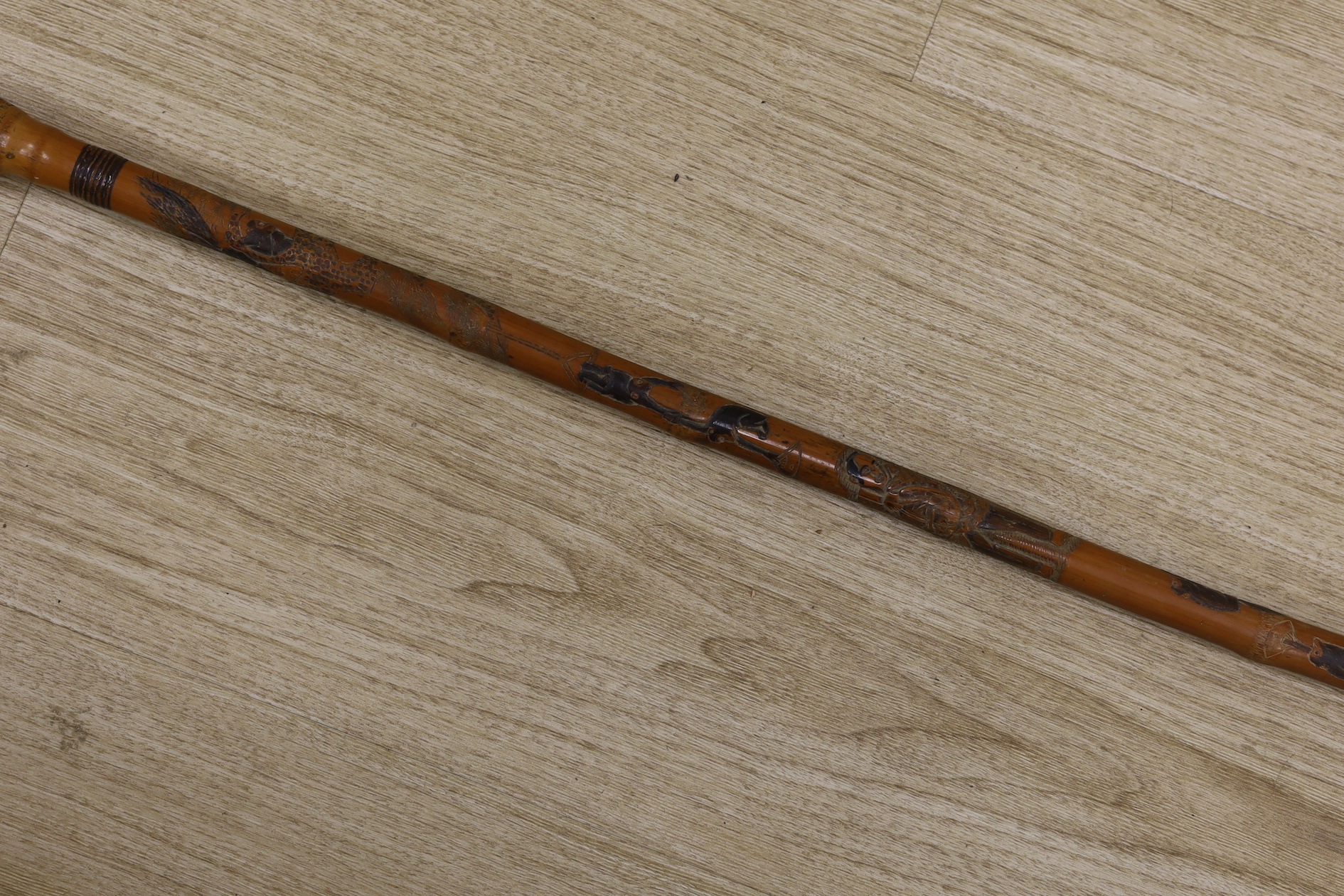 A Japanese carved and signed walking cane, 87cm high. Condition - fair to good